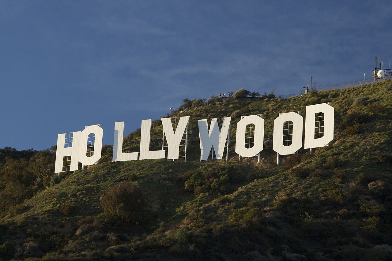 Real photograph of the white HOLLYWOOD letters on a hillside against a blue sky.